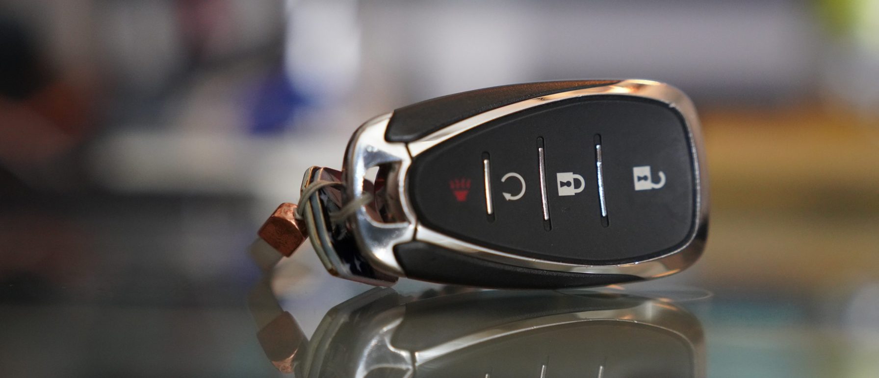 Locksmith programming a replacement car key fob on a vehicle